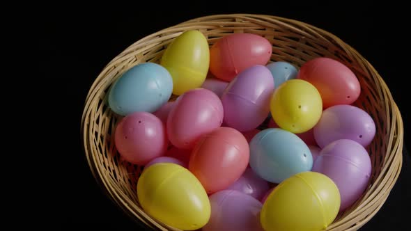 Rotating shot of Easter decorations and candy in colorful Easter grass