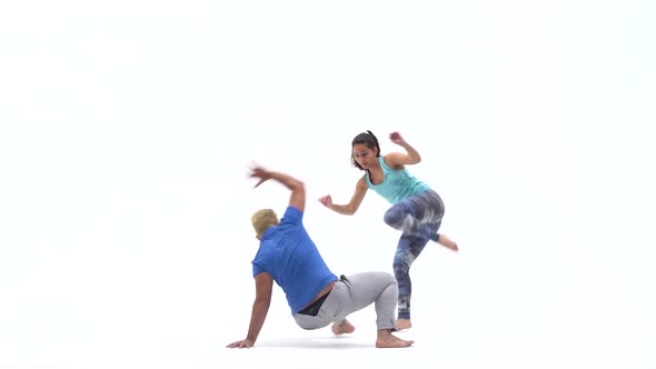 Woman and Man Are Practicing Capoeira in White Background of Studio. Afro-Brazilian Martial Art That