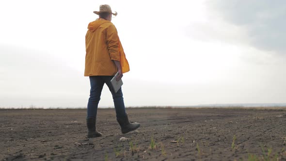 Farmer Inspects His Its Dry Field