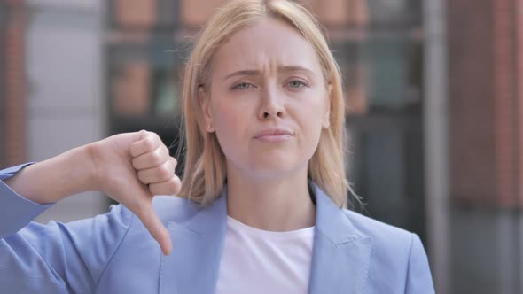 Thumbs Down by Blonde Businesswoman, Outdoor