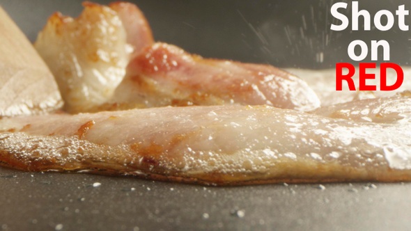 Slice Of Bacon On A Frying Pan A Closeup Shot On Red Camera