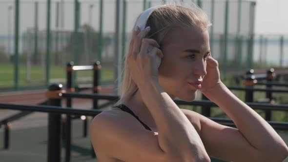 Sport Girl In Headphones Boxing Outdoors