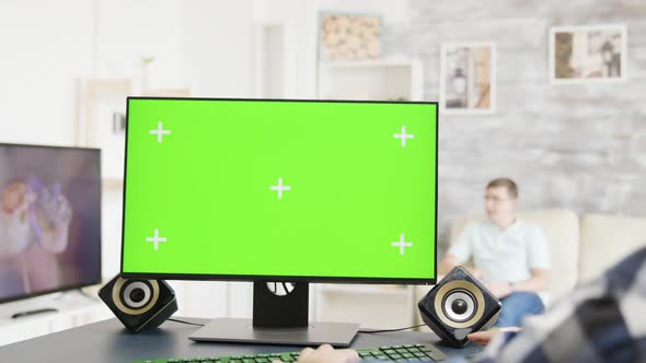 Man Working on Green Screen PC Display in Bright and Modern Flat