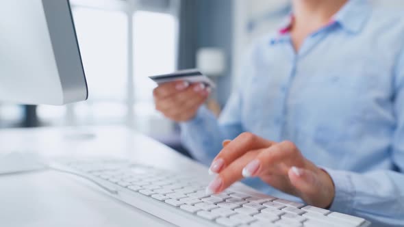 Female Hands Typing Credit Card Number on Computer Keyboard. Woman Making Online Purchase. Online