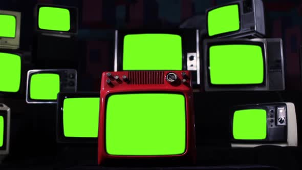 Stack of Old TV turning on Green Screens. Iron Tone.