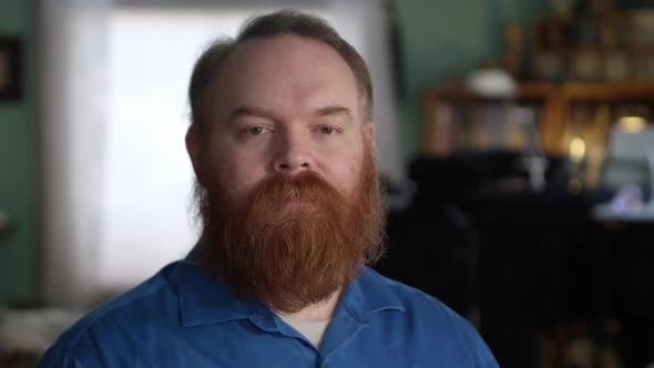 Face of man with red hair and beard looking at camera