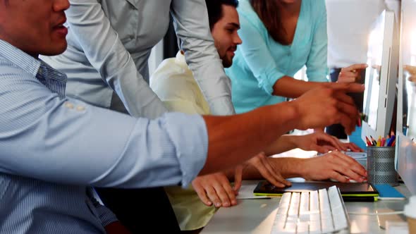 Business executives working over computer