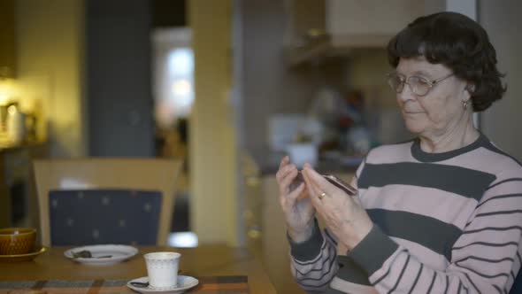 Happy Senior Woman Talking on the Phone at Home