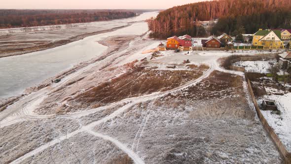 Frostcovered Orange Bank of a Frozen River Aerial View