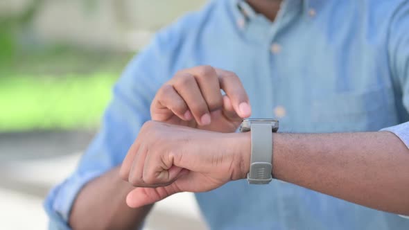 Close Up of African Man Using Smartwatch