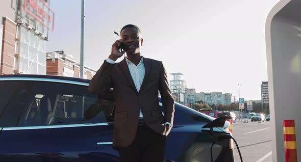 Portrait Of A Handsome Joyful Afro American Guy Which Has Pleasant Mobile