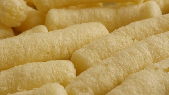 Corn flips puffs unhealthy food close-up 4K 2160p 30fps UltraHD panning footage - Slow pan  puffcorn