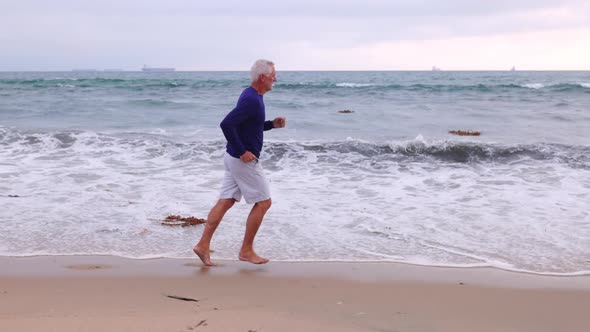 Mature Man Exercising At The  Beach