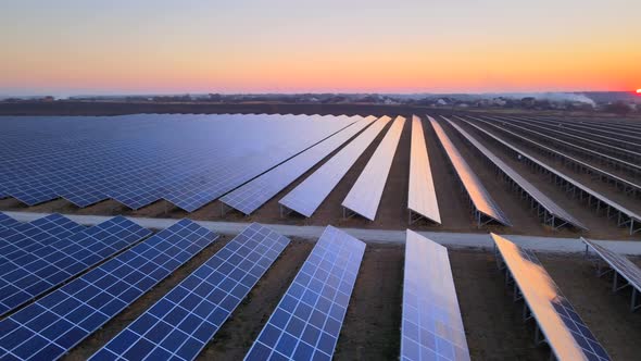 Aerial Drone View of Large Solar Panels at a Solar Farm at Bright Sunset in Early Winter