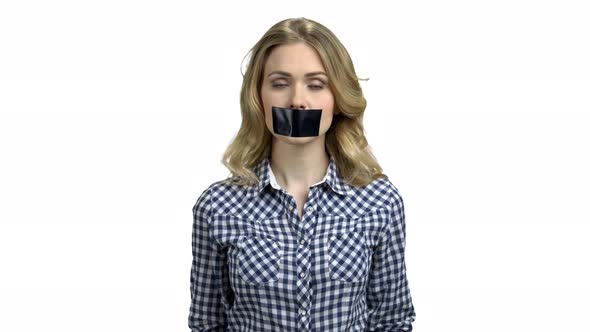 Young Woman with Black Tape on Her Mouth