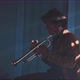 View of trumpeter playing in his apartment - VideoHive Item for Sale