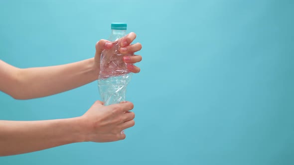Hand holding empty Plastic Bottles on blue background