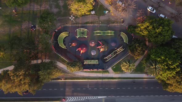 Aerial top down shot of kids playing games in park during sunset time in Buenos Aires,Argentina