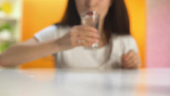 Happy Female Drinking Water and Putting Glass on Table, Health Care, Wellness