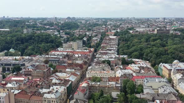 City skyline of old European buildings in Lviv Ukraine with cars driving on the main road
