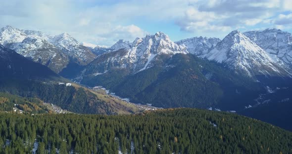 Aerial drone view of snow covered mountains in the winter