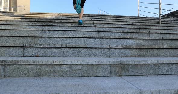 Fitness sports woman running up stairs in city