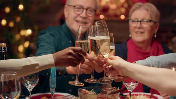 Festive Family Clinking Champagne Glasses While Enjoying Christmas Dinner at Home