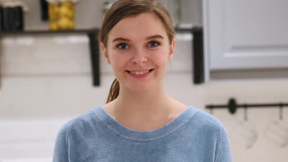 Portrait of Smiling Positive Woman at Home