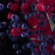 Blueberries and raspberries with mint leaves splashing in to the water.  - VideoHive Item for Sale