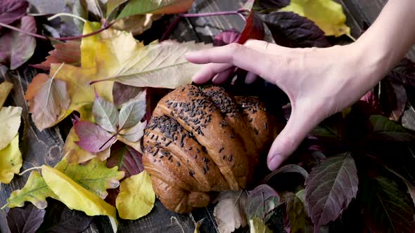 Good Autumn Morning with French Croissant and Autumn Leaves Over Wooden Rustic Background, Top View