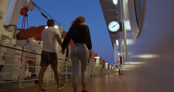 Couple Strolling on Deck on Cruise Ship in the Evening.