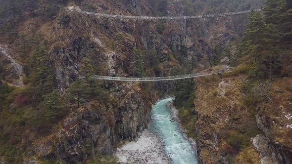 Suspension Bridge Named After Edmund Hillary In Canyon. Nepal. Aerial Footage