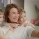 Mom Sits Taking a Selfie and Twin Daughters Run Up to Her - VideoHive Item for Sale