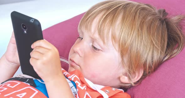 Baby Boy Playing with Mobile Phone alt