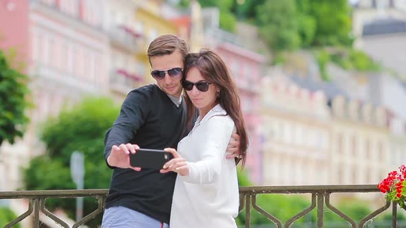 Romantic Couple Walking Together and Taking Selfie in Europe. Happy Lovers Enjoying Cityscape