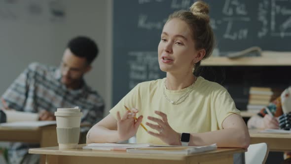 Female College Student Asking Question during Class