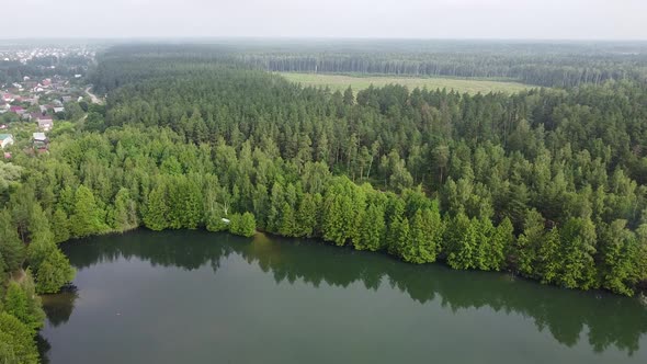 Drone Flying Over Lake and Forest