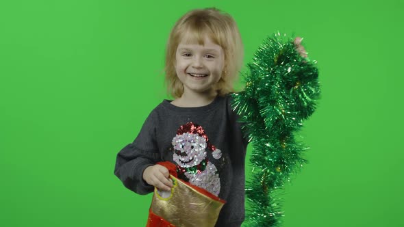 Happy Beautiful Little Girl in a Sweater with a Snowman. Christmas. Chroma Key