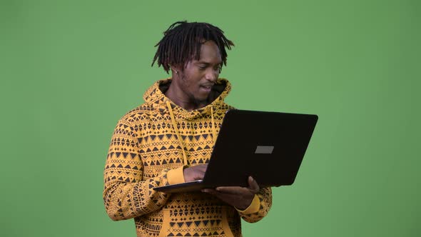 Young Handsome African Man Using Laptop