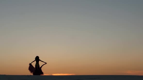 Graceful Movements of a Dancer, Dancing Belly Dance While on the Beach. Silhouettes
