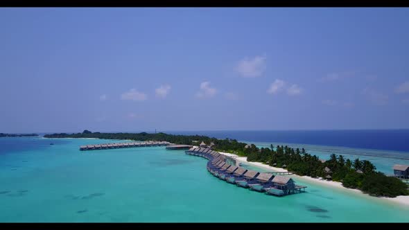 Aerial drone view tourism of relaxing seashore beach break by blue green water and white sandy backg
