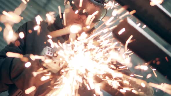 A Piece of a Metal Beam Is Getting Cut with Lots of Sparks