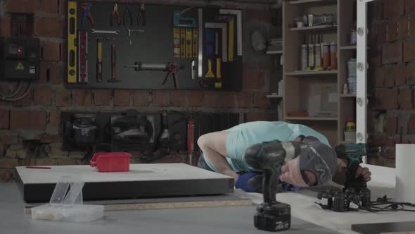 Portrait Skill Craft Master Engineer Focused on Drilling a Hole with Tool on the Background