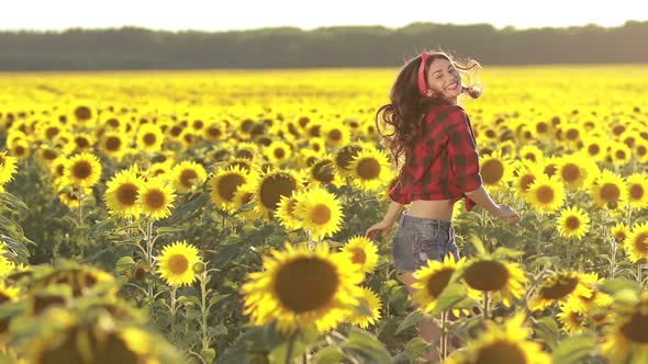 Emotional Charming Girl Jumping in Sunflower Field