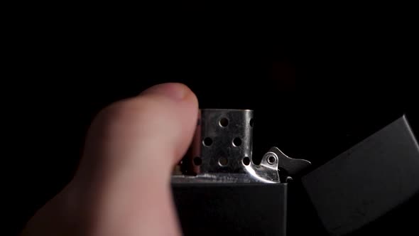 Close up shot of trying to turn on a zippo lighter.