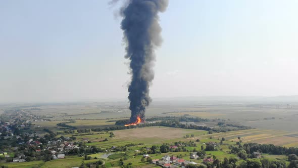 Aerial View of Huge Fire View From Quadcopter. Black Smoke Rises High Into the Sky. Fire on the alt
