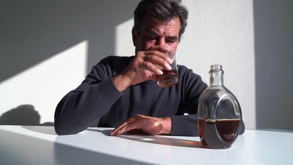Depressed Mature Man Drinking Alcohol