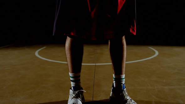 Basketball player holding basketball in the court 4k