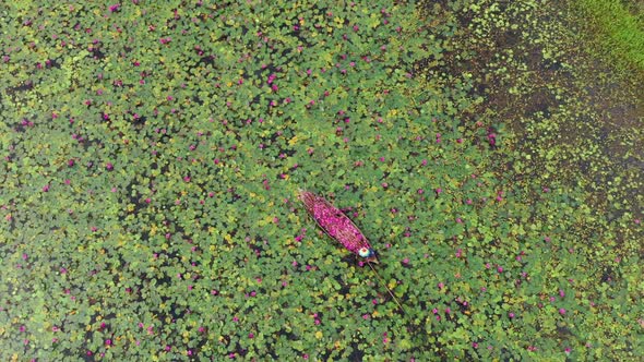 Aerial view of a fisherman working on a small canoe, Dhaka, Bangladesh.