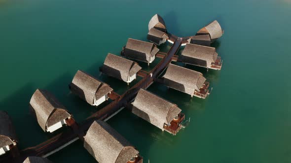 Girl walks between overwater bungalows at a resort in Fiji, luxury hotel surrounded by tropical seaw